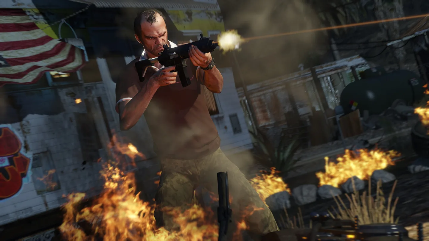 Trevor Philips firing a submachine gun among burning debris