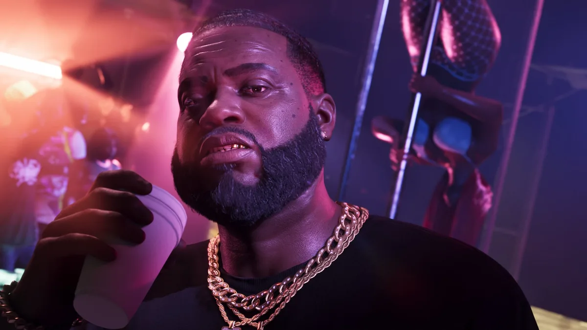 Close-up of Boobie Ike with gold chains and a cup, a dancer on a pole behind him under pink light, official GTA 6 screenshot
