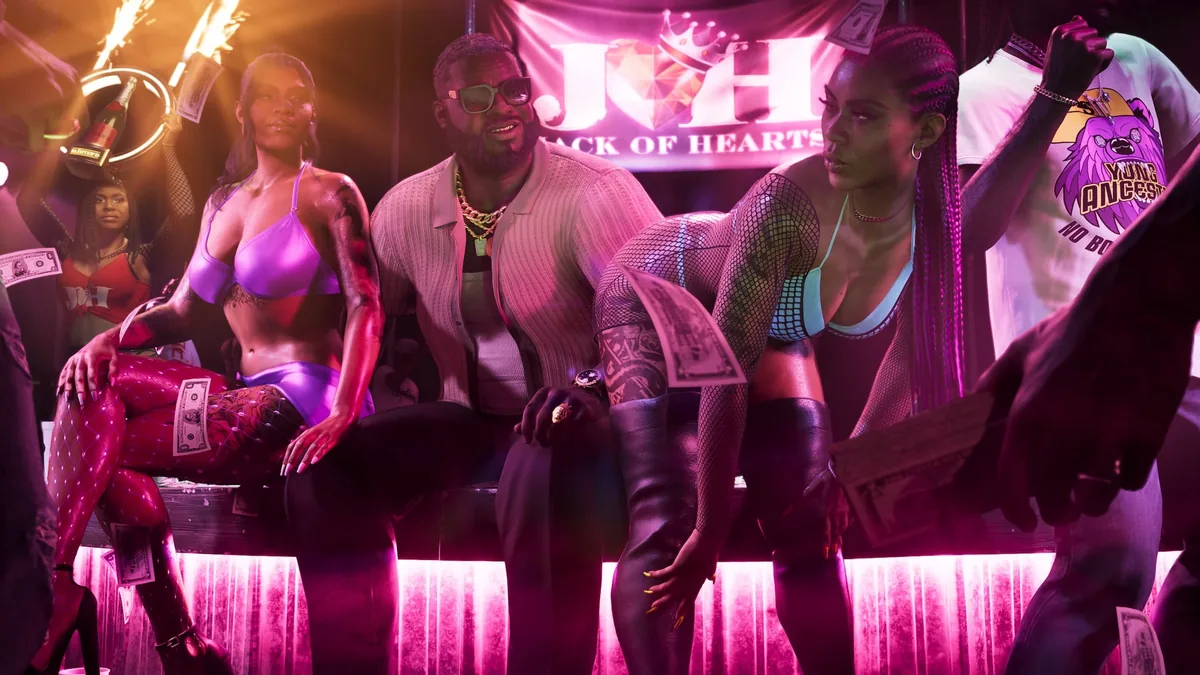 Boobie Ike on the Jack of Hearts stage between two dancers as banknotes rain down, official GTA 6 screenshot