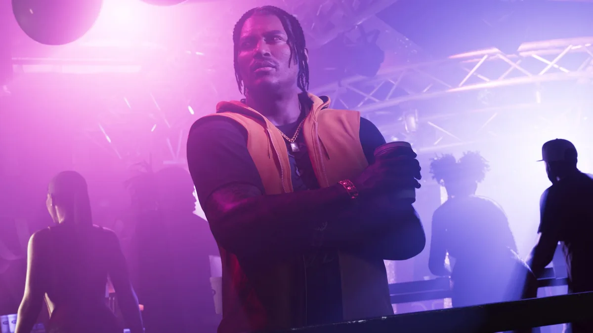Dre'Quan Priest in an orange hooded vest holding a cup in a smoky club under purple light, official GTA 6 screenshot