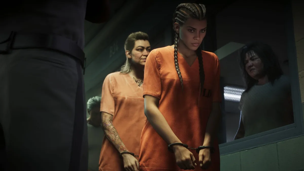Lucia Caminos in an orange prison uniform and handcuffs being led through Leonida Penitentiary, official GTA 6 screenshot