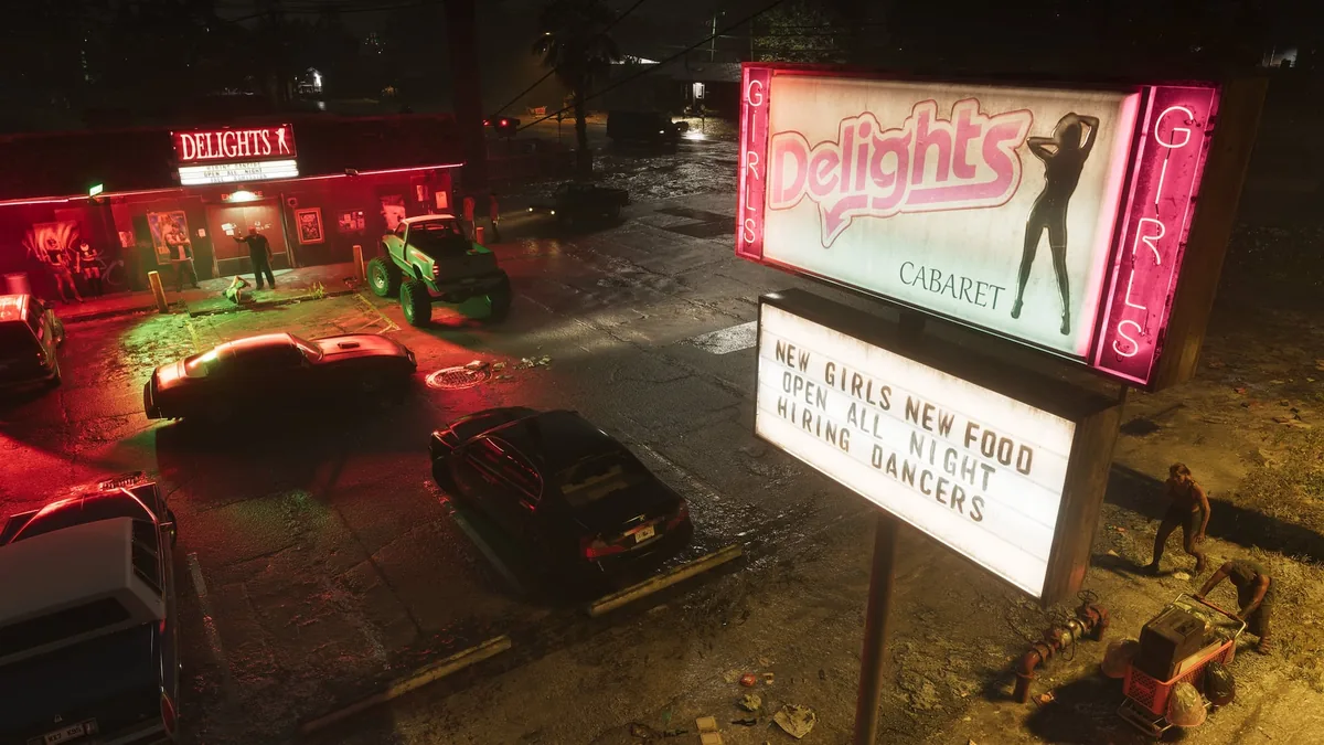 Parking lot of the Delights cabaret at night in Port Gellhorn with a lifted green truck and a sign reading new girls, new food, open all night, official GTA 6 screenshot