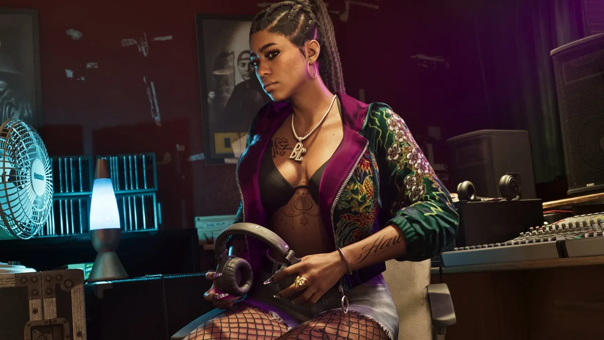 Bae-Luxe of Real Dimez sitting in a recording studio holding headphones, a BL chain around her neck, official GTA 6 screenshot