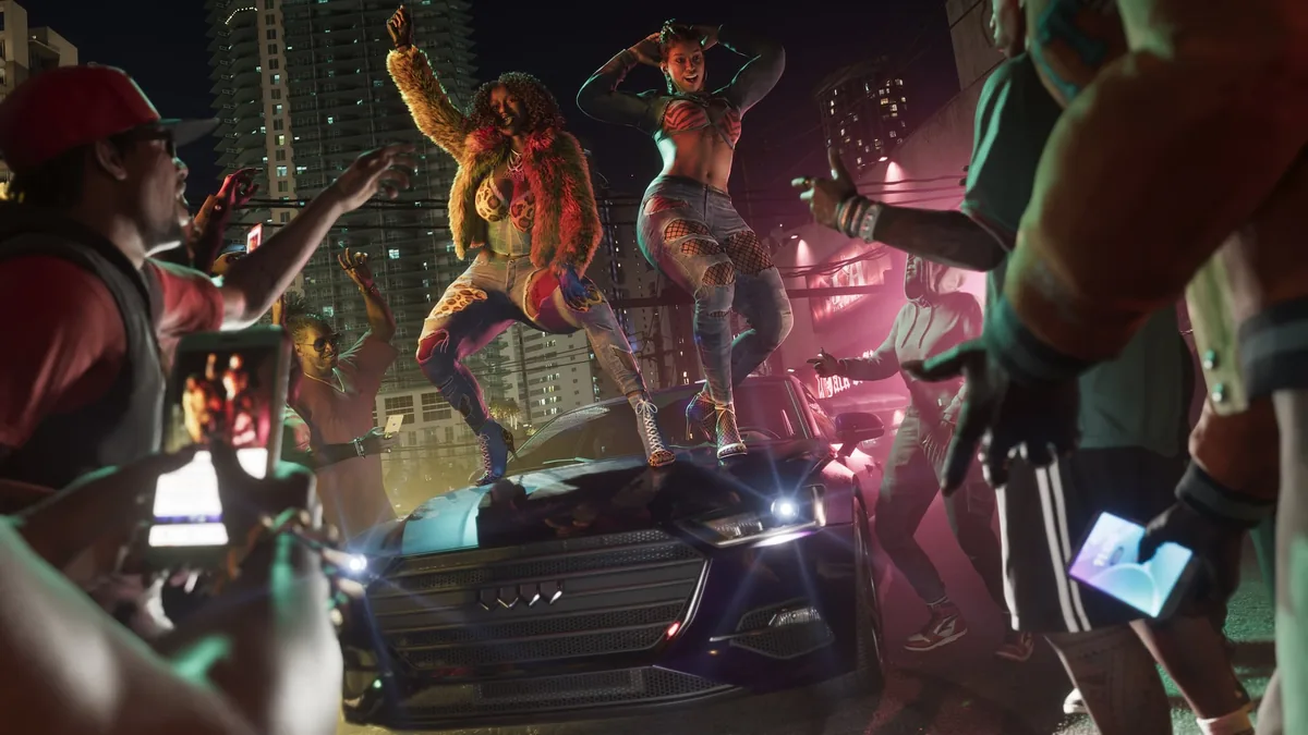 Real Dimez dancing on the hood of a car in a Vice City street at night while a crowd films with phones, official GTA 6 screenshot