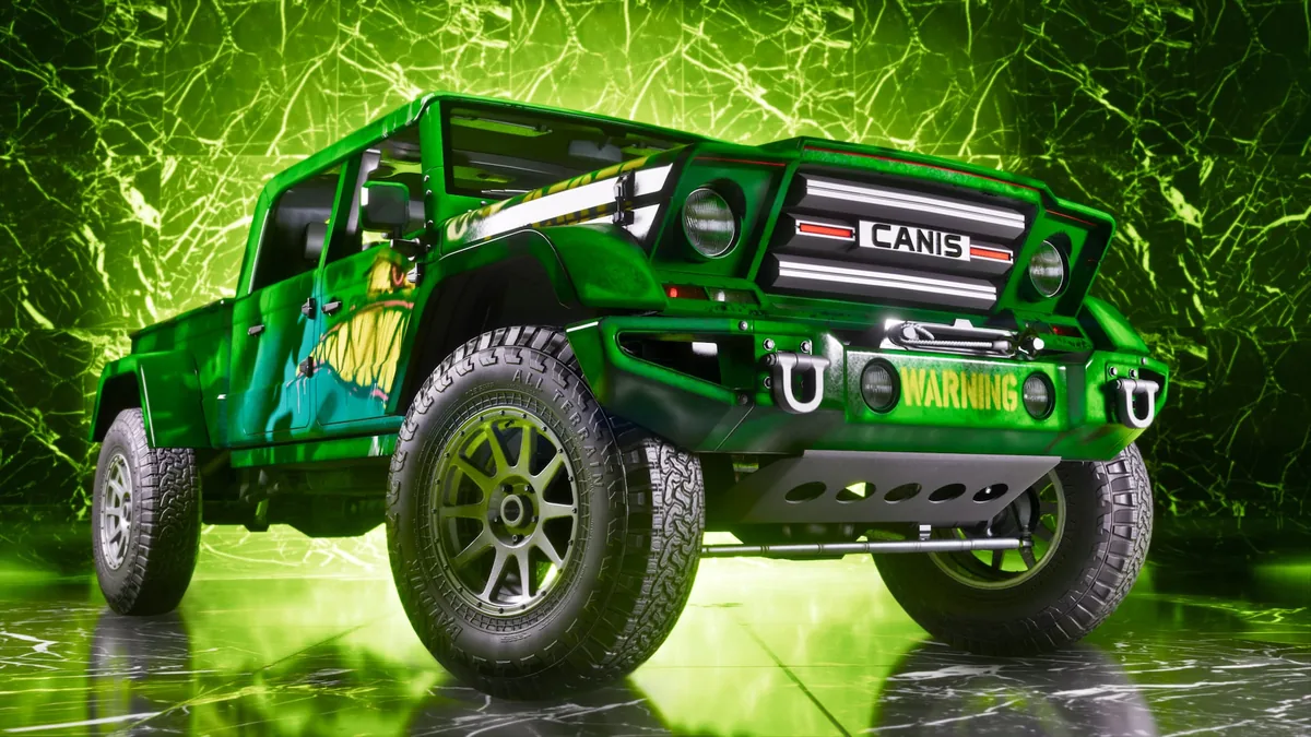 A green Canis crew-cab off-road pickup with a winch and a Warning livery in One-Eyed Willie's Mod Shop, official GTA 6 screenshot