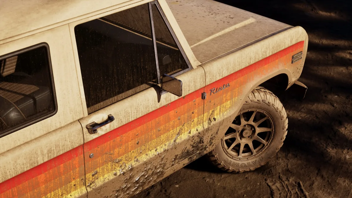 Side view of a mud-splattered beige Riata off-roader with red, orange and yellow stripes, official GTA 6 screenshot