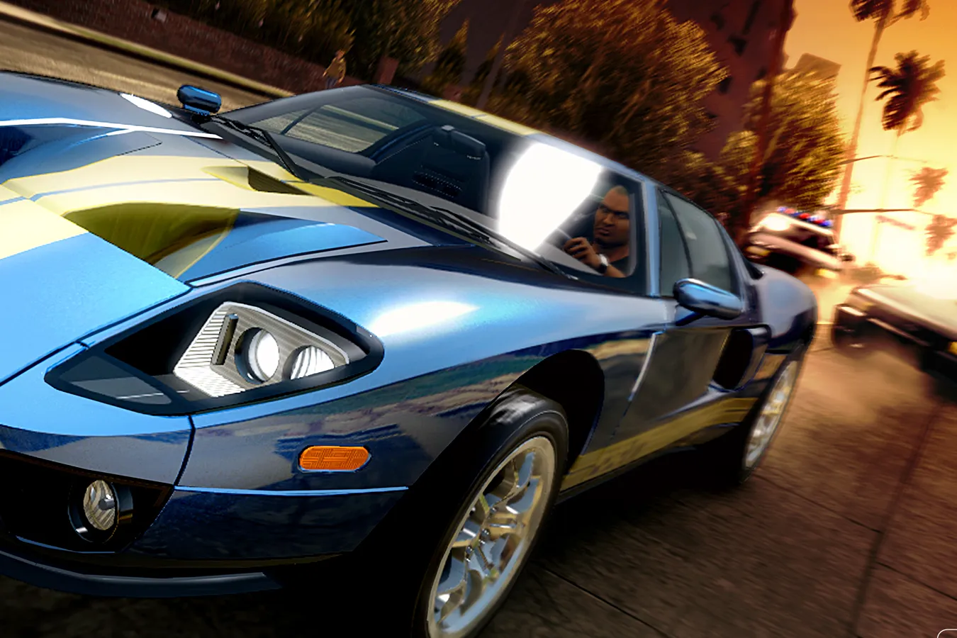 A blue Ford GT chased by police cars at sunset in Midnight Club: Los Angeles